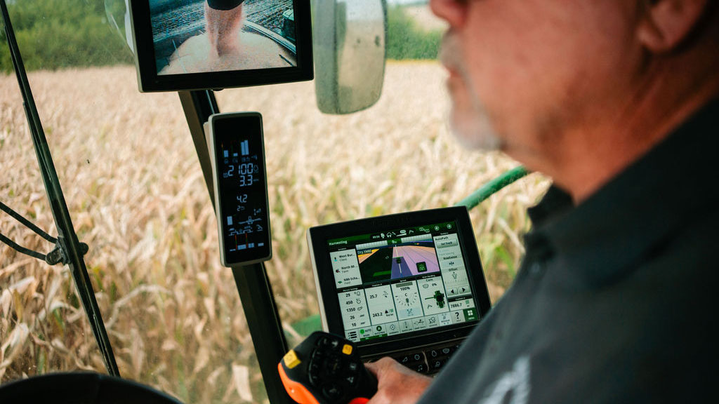 farmer uses John Deere technology to harvest corn in Illinois